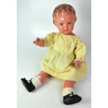 SCHILDKROT; a large mid-20th century plastic jointed doll, in a cream smocked dress with bloomers,