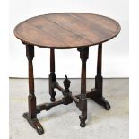 A Georgian-style oak circular folding table with dished top above folding gateleg turned and block