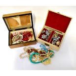 A quantity of costume jewellery to include brooches, faux pearl necklaces, beaded necklaces,