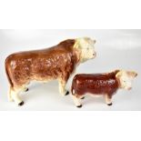MELBA WARE; two figures of Hereford bulls, the largest height 26cm, length 43cm (2).