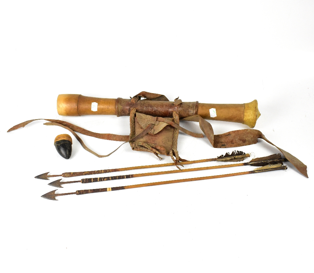 An African carved wooden quiver with leather mounts and straps, length 60cm,