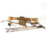 An African carved wooden quiver with leather mounts and straps, length 60cm,