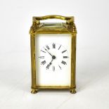 An early 20th century French brass carriage clock, the white dial set with Roman numerals,