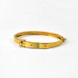 A 9ct yellow brushed gold bangle in the form of a belt and buckle,
