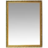A large modern bevel edged rectangular wall mirror, the frame moulded with pomegranates and leaves,
