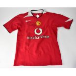 MANCHESTER UNITED; a football shirt bearing the signature of Wayne Rooney.