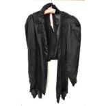 A Victorian-style black beaded mourning jacket with leg o'mutton sleeves and crossover tie to front,