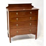 An Edwardian mahogany with string inlay two-over-three chest of drawers,
