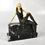 A reproduction Art Deco figure of a lady in ivorine and cast metal,