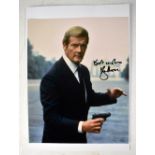 ROGER MOORE; a colour photograph bearing his signature, 25 x 22.5cm.