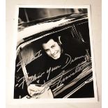 JOHN TRAVOLTA; a black and white photograph bearing his signature.