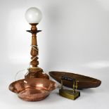 A carved wooden Baroque-style table lamp with opaque glass shade, a copper planished bowl,