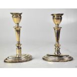 A pair of Edward VII hallmarked silver column candlesticks to elliptical stepped bases,