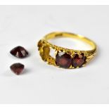 An 18ct yellow gold ladies' dress ring set with four graduating garnets, size N, approx 4.2g.