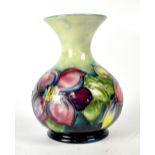 MOORCROFT; a baluster vase with green-blue drip glaze ground and tube lined 'Anemone' pattern,