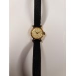 SHIELD; an 18ct yellow gold ladies' wristwatch, the dial set with baton numerals,