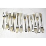 Twelve George III hallmarked silver Fiddle pattern forks of varying sizes and a matching spoon,