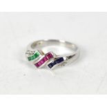 A white metal ladies' dress ring set with multicoloured baguette stones in blues,