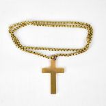 A 9ct gold cross stamped '375', length 4.5cm, on a yellow metal belcher link chain.