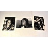 JAMES BROWN; three black and white photographs, each bearing the star's signature (3).