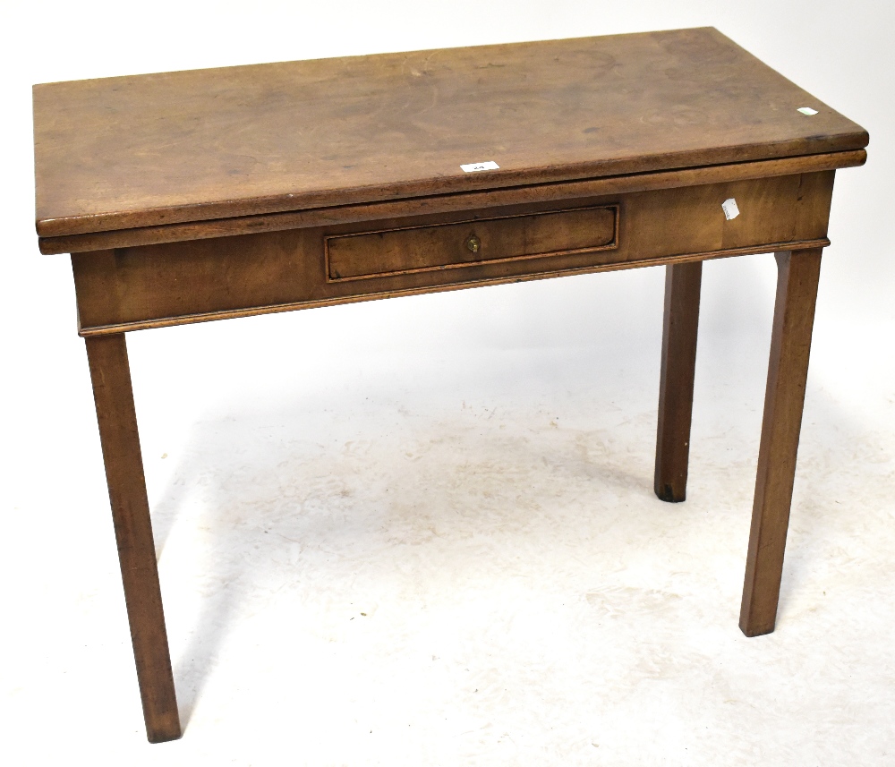 A mahogany fold-over tea table with single frieze drawer, raised on square section supports,