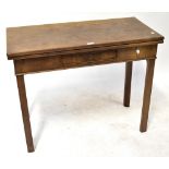 A mahogany fold-over tea table with single frieze drawer, raised on square section supports,