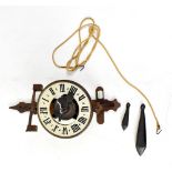 A rustic open wall clock with simple wooden movement,