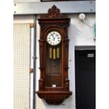 An early 20th century walnut cased triple weight Vienna wall clock,