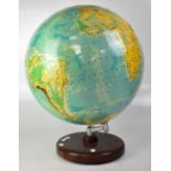 A Phillips 19" relief globe on a wooden stand, height 60cm.