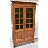 An early 20th century oak two-door cabinet,