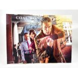 DOCTOR WHO; an oversized reproduced photograph bearing several signatures, including Peter Capaldi.