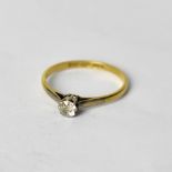 An 18ct yellow gold ring with diamond solitaire, set in platinum, size P, approx 1.7g.
