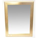 A contemporary gilt framed wall mirror with bevel edge plate and hatched decoration to the frame,