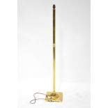 A contemporary brass standard lamp with reeded column on square section base, height 137cm.