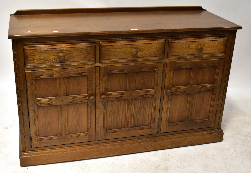 A mid-20th century sideboard, with raised back above three drawers and three panelled doors,