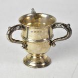 A George VI hallmarked silver three-handled trophy, to a circular stepped base, Birmingham 1937,