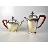 A George V hallmarked silver teapot and matching hot water pot of octagonal form,