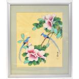 An early 20th century gouache on silk of exotic birds in floral setting, signed lower right,