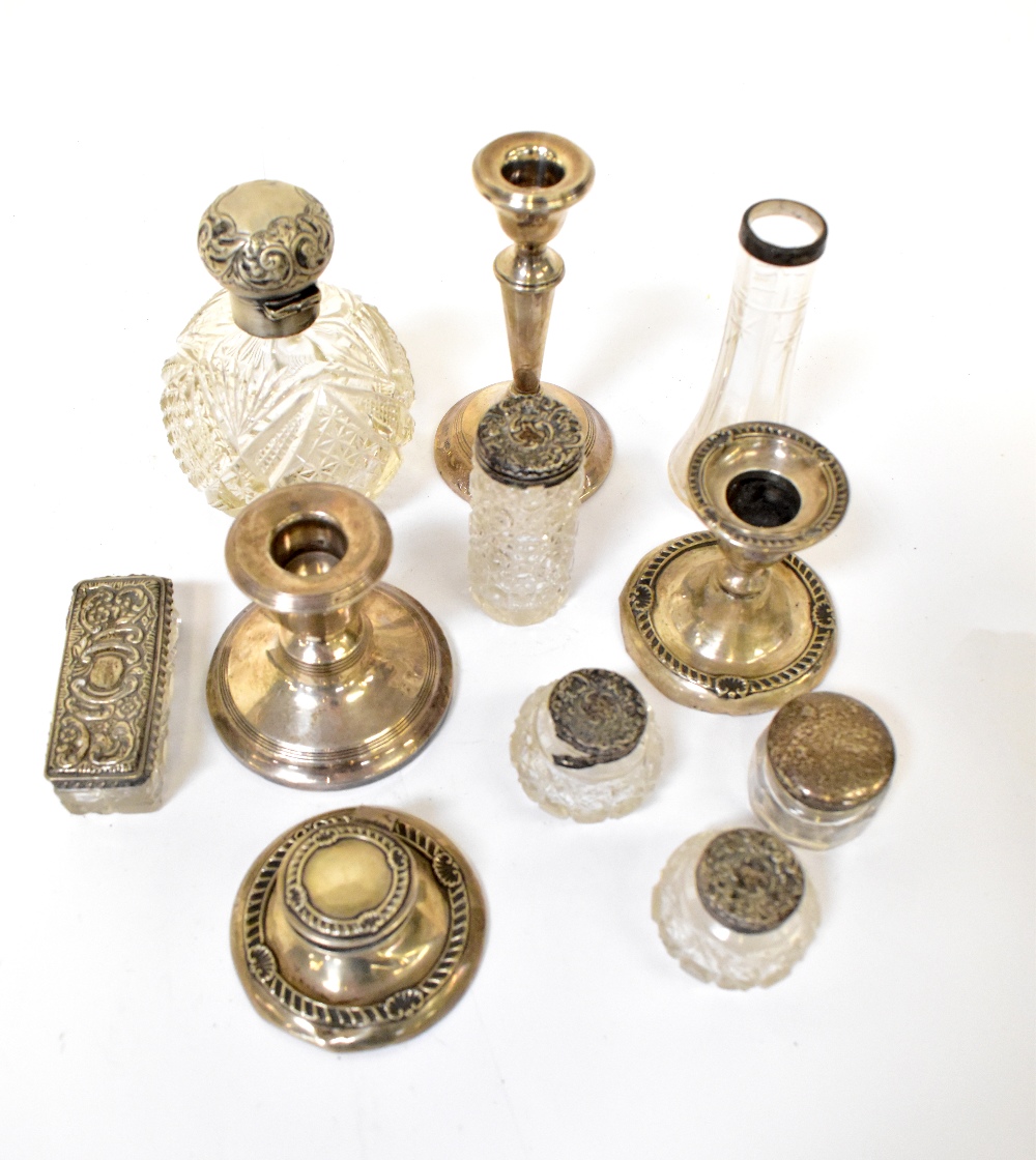 A small mixed lot of silver comprising a squat candlestick with matching capstan inkwell,