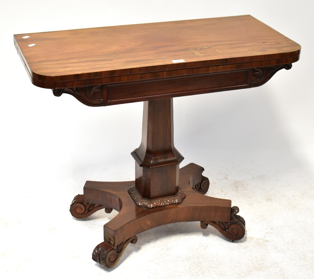 A Victorian mahogany fold-over tea/games table to column support and quadripartite base,