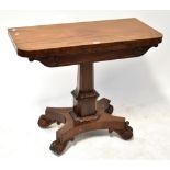 A Victorian mahogany fold-over tea/games table to column support and quadripartite base,