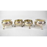 A pair of George V hallmarked silver salts, with beaded rims to outswept paw supports,