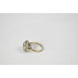 An 18ct yellow and white gold floral set diamond ring, with four diamonds to the centre,