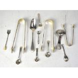 Two pairs of hallmarked silver sugar tongs, a shell-form caddy spoon,