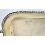 A hallmarked silver rectangular twin-handled tray with rope trim, marks rubbed,