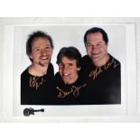 THE MONKEES; a colour photograph bearing the signatures of Peter Tork, Davy Jones and Mickey Dolenz,