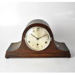 An early 20th century oak cased chiming Napoleon hat mantel clock,