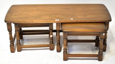 ERCOL; a mid-20th century nest of three tables, with turned and block stretchered supports,