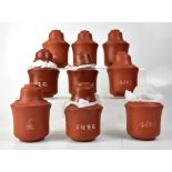 A quantity of terracotta sake warmers with cups (2).