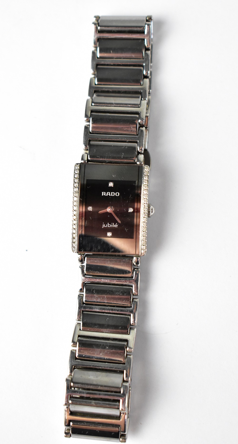 RADO; a 'Jubilé' ladies' tank watch, the black dial set with four small diamonds at 12, 3,